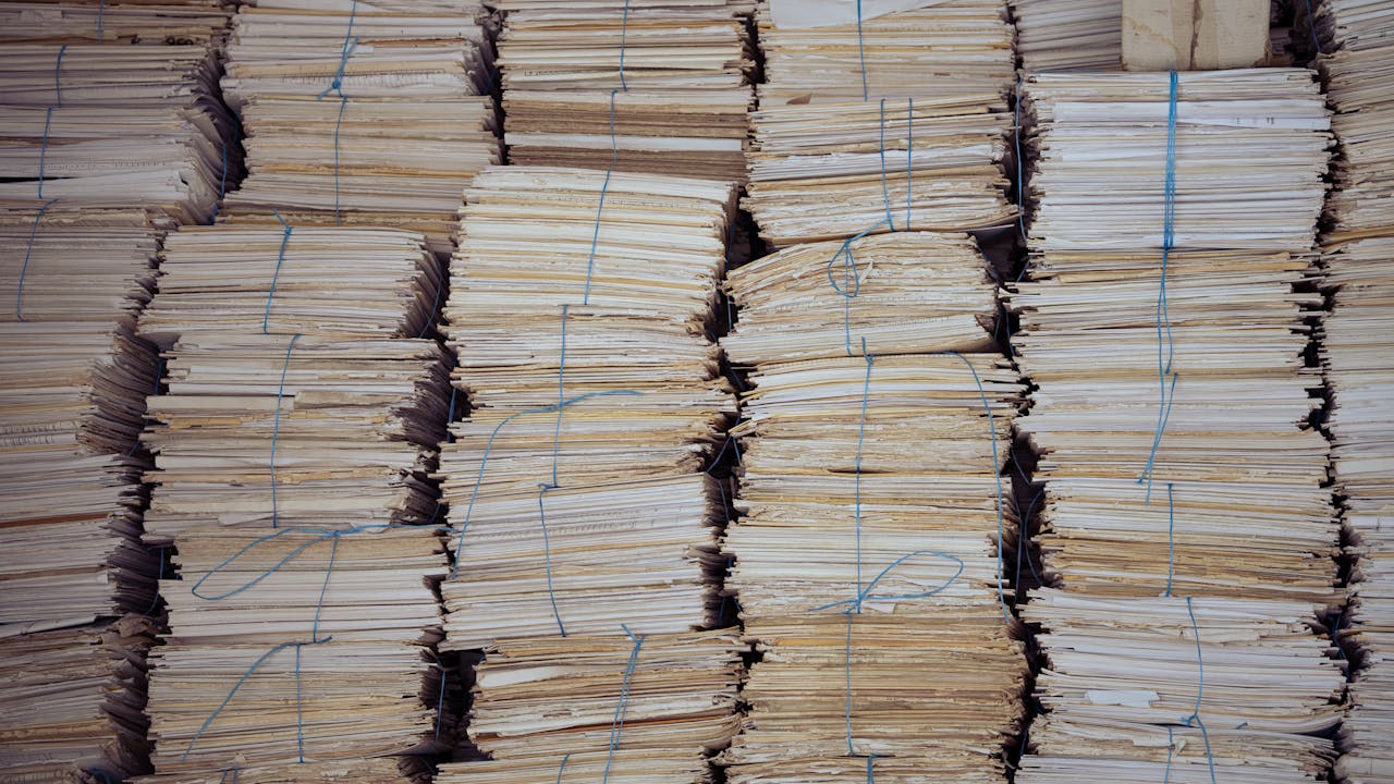 High stacks of organized, bound paper bundles create a structured and neat appearance.